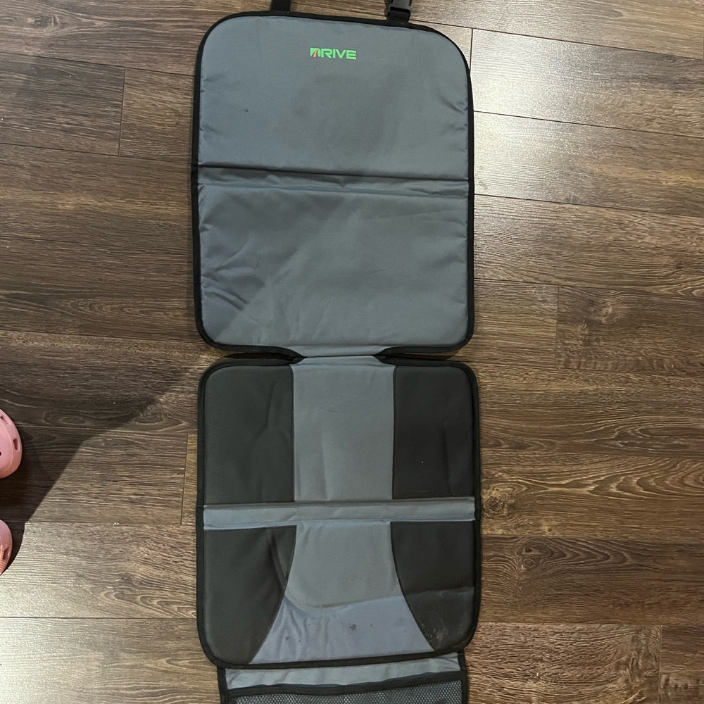 Gray and Black car seat protector for child seat.